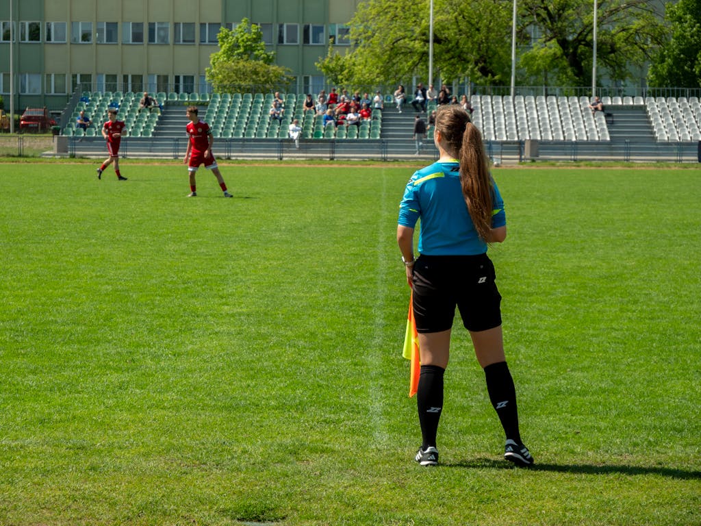 Female football referee oversees a match at a stadium in Wrocław, Poland.